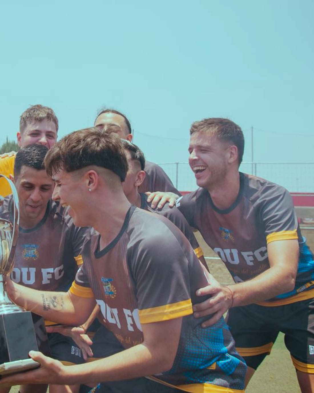 A team celebrating with the trophy
