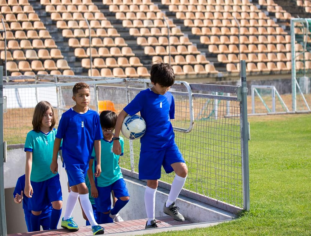 Junior players walking out onto the field